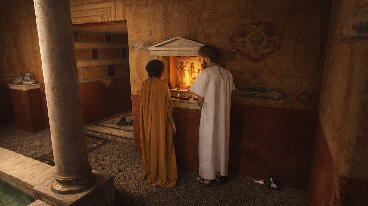 Two people in historical attire at an ancient altar, Setas de Sevilla tour.