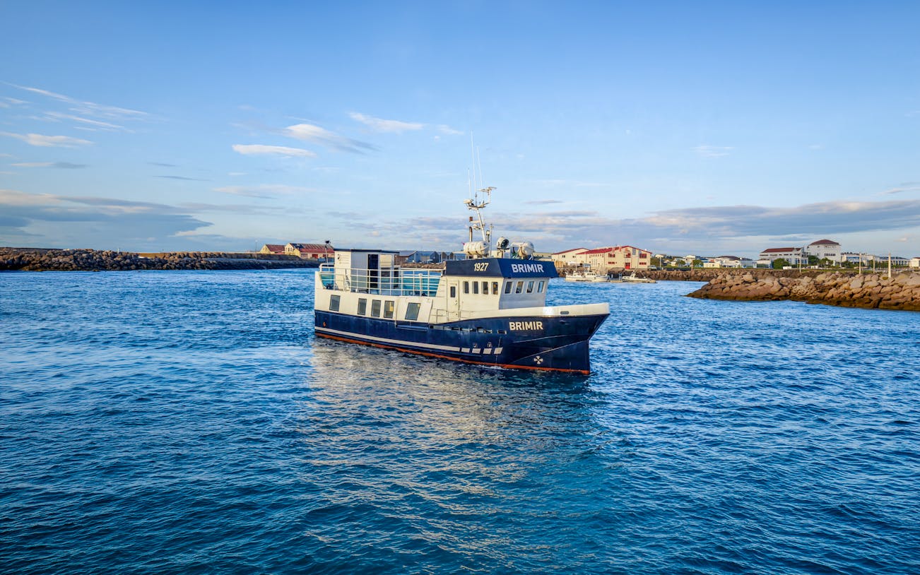Whale watching boat in Akureyri harbor, Iceland, ready for a cruise-friendly tour.
