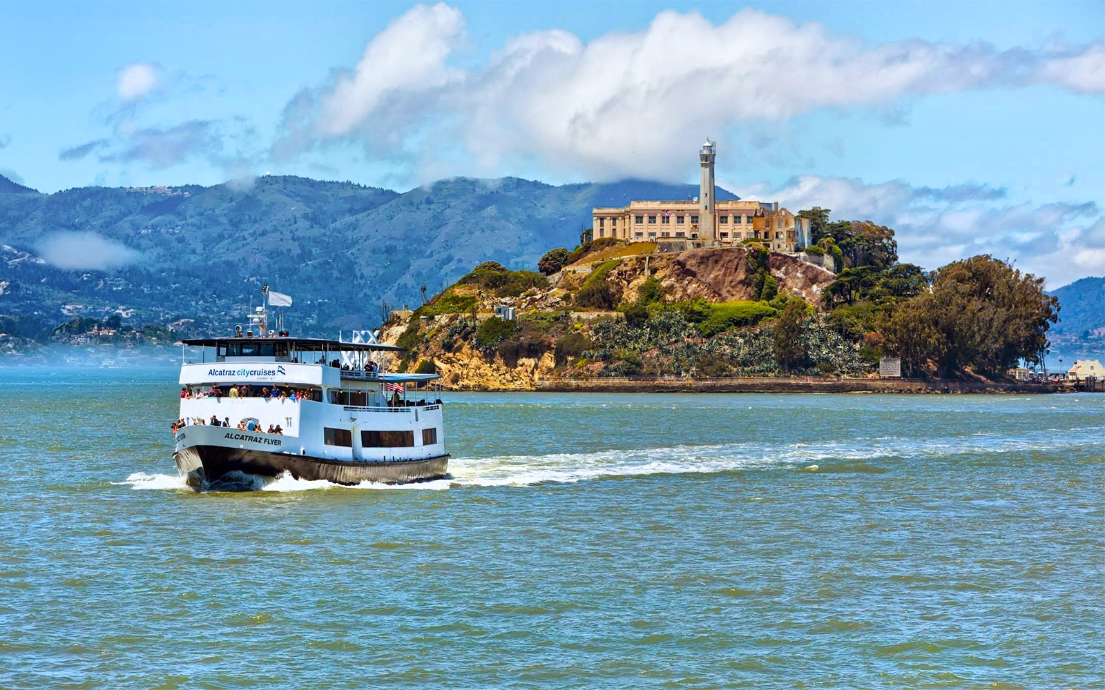 Ferry approaching Alcatraz Island with historic prison in San Francisco Bay.