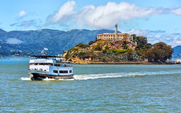 Ferry approaching Alcatraz Island with historic prison in San Francisco Bay.