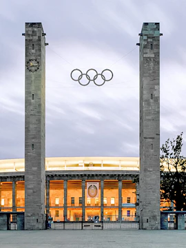 Exterior view of Olympiastadion Berlin with Olympic rings and entrance.
