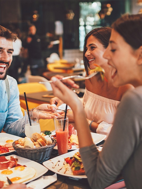 Dining experience at Flora Danica Paris on the Champs Elysées with friends enjoying aperitifs.