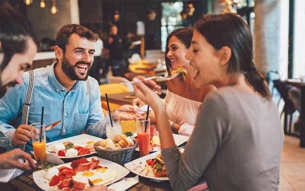 Dining experience at Flora Danica Paris on the Champs Elysées with friends enjoying aperitifs.