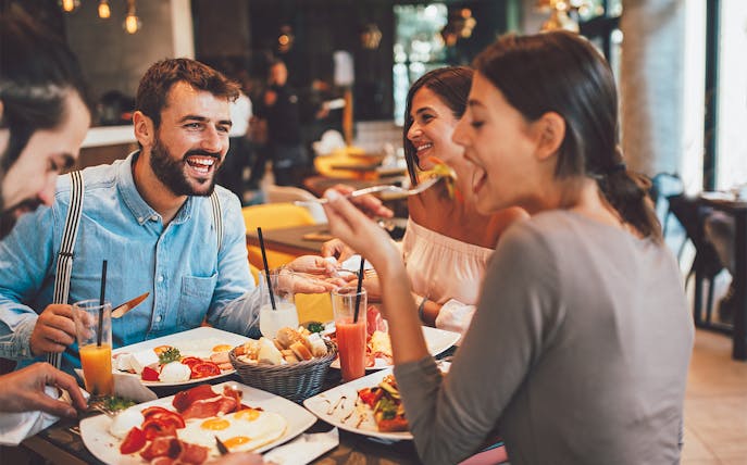 Dining experience at Flora Danica Paris on the Champs Elysées with friends enjoying aperitifs.