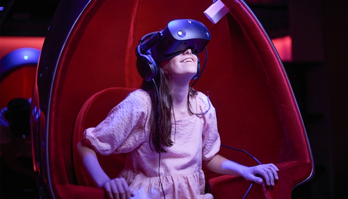 Young girl experiencing virtual reality at Melbourne Skydeck Voyager Theatre.