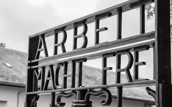 Entrance gate with "Arbeit Macht Frei" at Dachau Memorial Site, Germany.