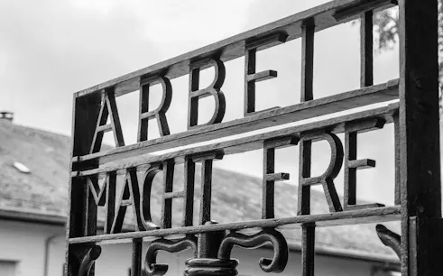 Entrance gate with "Arbeit Macht Frei" at Dachau Memorial Site, Germany.