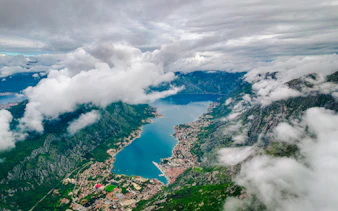 Aerial view of Kotor Bay surrounded by mountains and clouds, Montenegro.