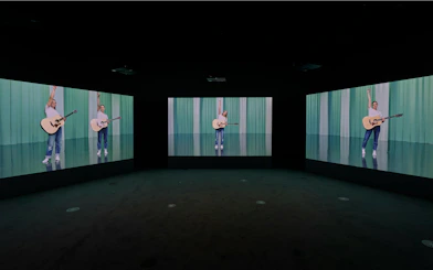 Multiscreen display of Ragnar Kjartansson's Mercy exhibition at National Gallery of Victoria.