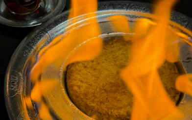 Flaming Tandoori Maggi dish served in Istanbul during a traditional Turkish dinner.