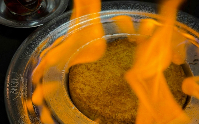 Flaming Tandoori Maggi dish served in Istanbul during a traditional Turkish dinner.