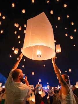 People releasing lanterns at Yeepeng Lanna Festival in Chiang Mai, Thailand.