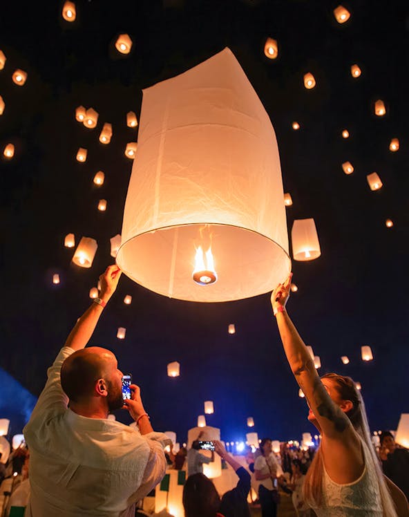 People releasing lanterns at Yeepeng Lanna Festival in Chiang Mai, Thailand.