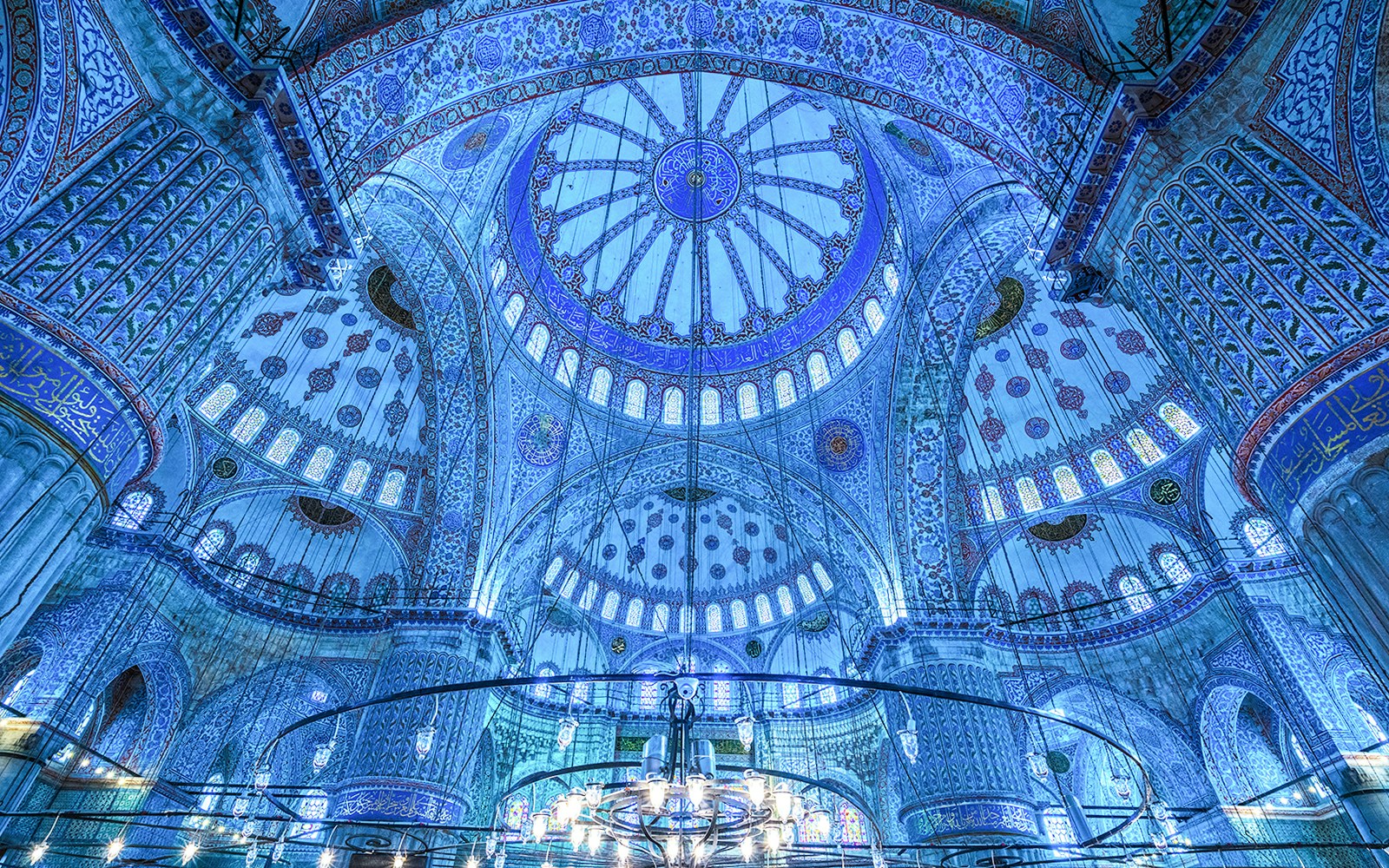 Interior view of the Blue Mosque's ornate dome and intricate tilework in Istanbul, Turkey.