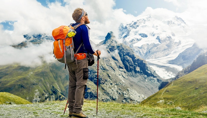 Hikers on trail with snow-capped Klein Matterhorn in background, Zermatt, Switzerland.