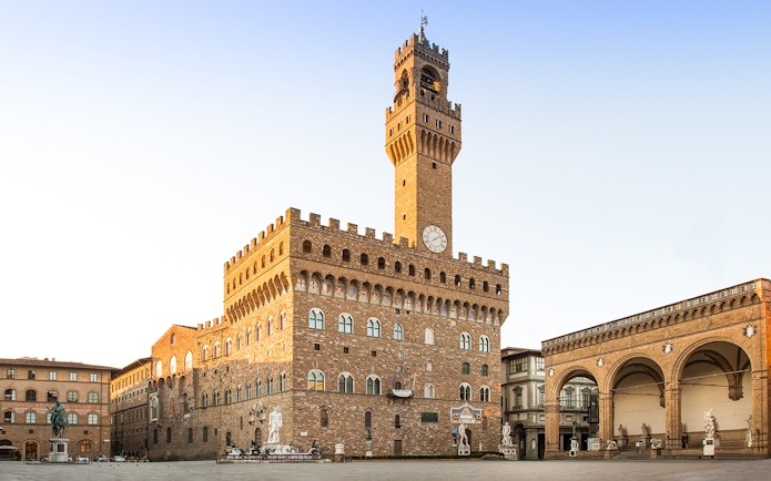 Palazzo Vecchio exterior view with clock tower in Florence, Italy.