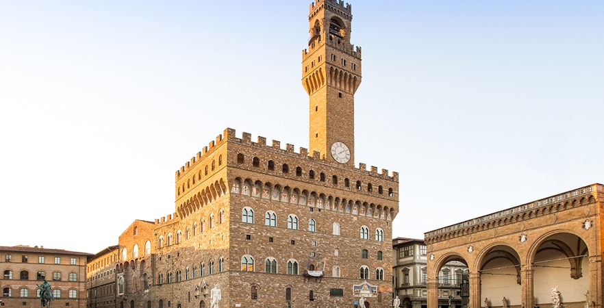 Palazzo Vecchio exterior view with clock tower in Florence, Italy.