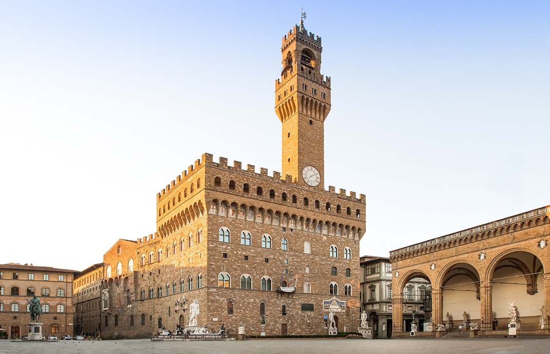 Palazzo Vecchio exterior with clock tower in Florence, Italy.