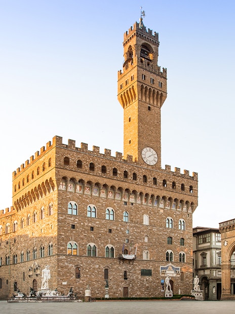 Palazzo Vecchio exterior view with clock tower in Florence, Italy.