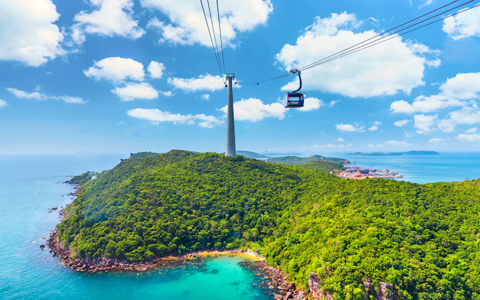 Cable car over lush island landscape at Sun World Hon Thom, Phu Quoc.