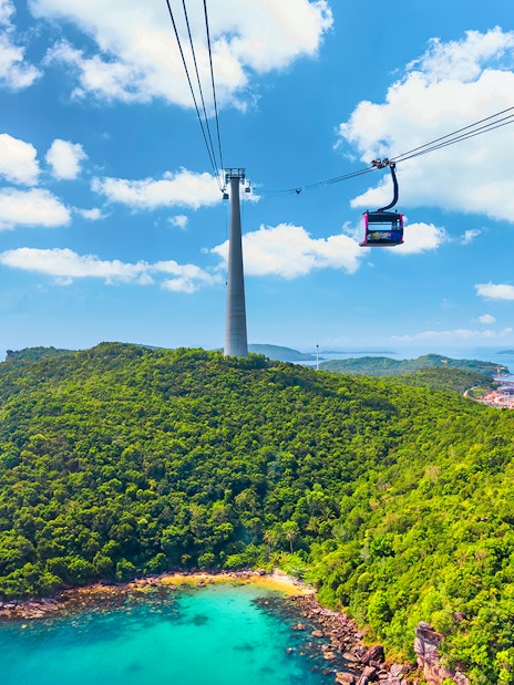Cable car over lush island landscape at Sun World Hon Thom, Phu Quoc.