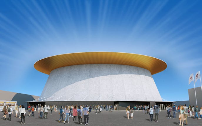 Crowd outside a pavilion at Expo 2025 Osaka with flags and blue sky.