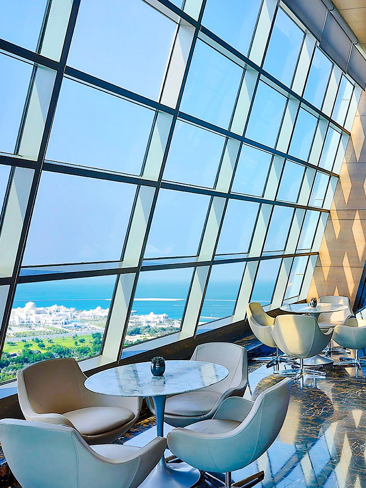 Observation Deck at 300, Etihad Tower, Abu Dhabi with city and sea view through large windows.
