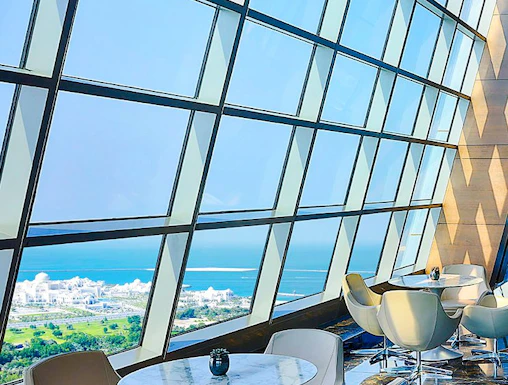 Observation Deck at 300, Etihad Tower, Abu Dhabi with city and sea view through large windows.