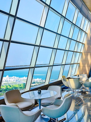 Observation Deck at 300, Etihad Tower, Abu Dhabi with city and sea view through large windows.