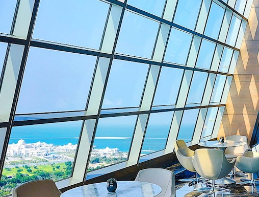 Observation Deck at 300, Etihad Tower, Abu Dhabi with city and sea view through large windows.