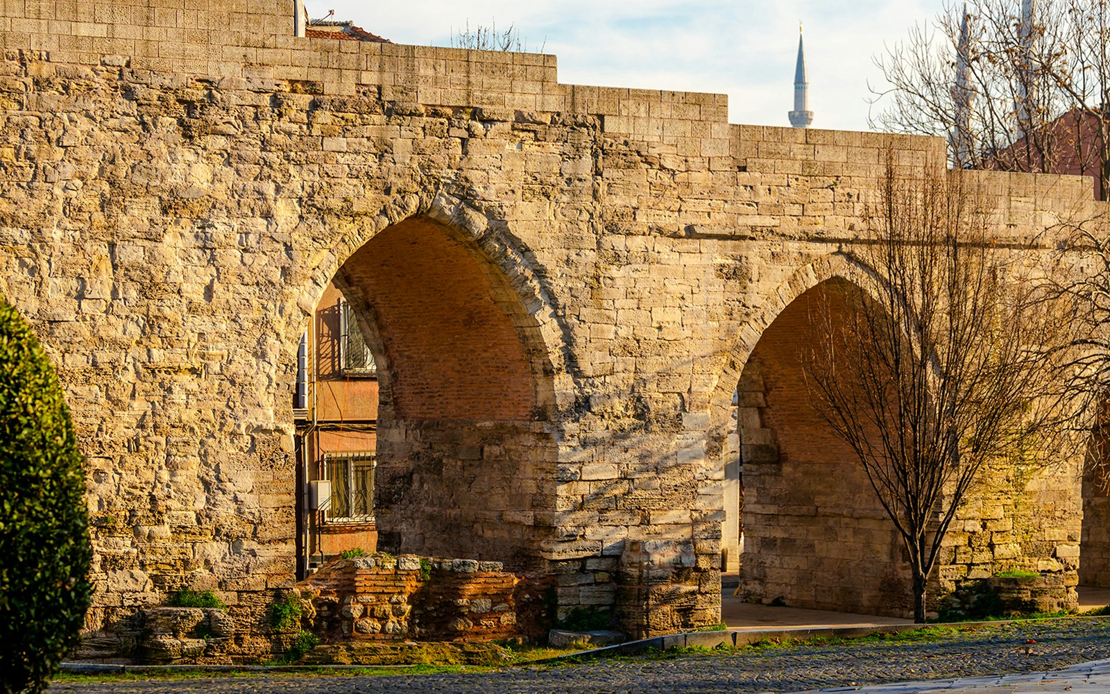 Aqueduct of Valens arches with a distant minaret in Istanbul, Turkey.