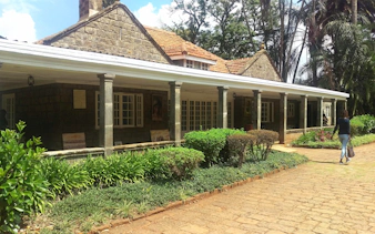 Karen Blixen Museum in Nairobi with stone facade and lush garden.