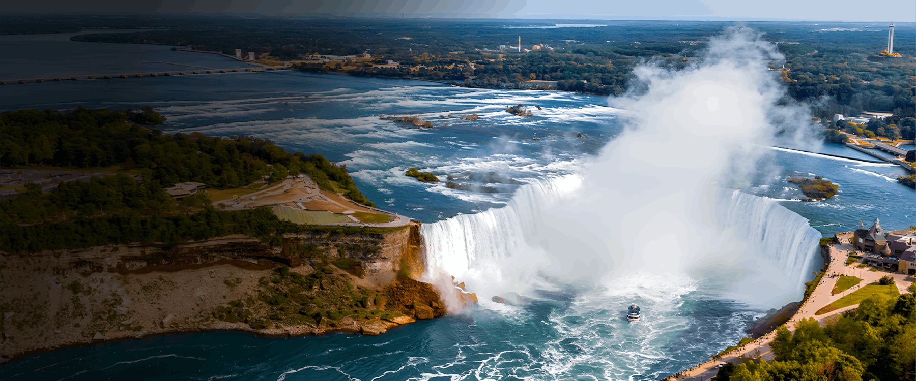 Niagara Falls aerial view with boat approaching waterfall, United States.