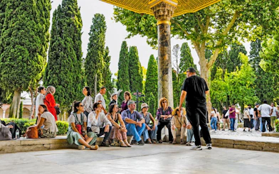 Group of tourists listening to a guide at Topkapi Palace, Istanbul.
