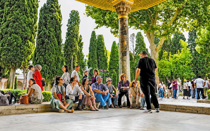 Group of tourists listening to a guide at Topkapi Palace, Istanbul.
