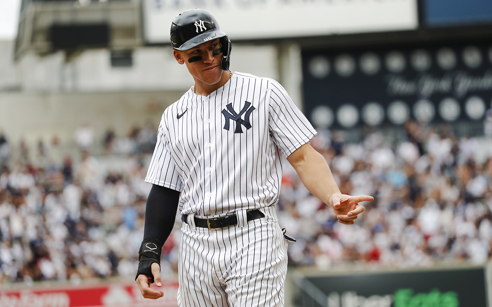 Yankees player in pinstripe uniform on the field at Yankee Stadium.