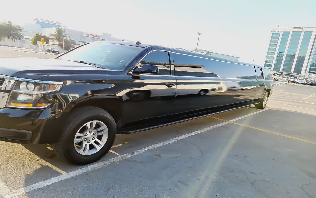 Black limousine parked in Dubai for private hourly rental with hotel transfers.