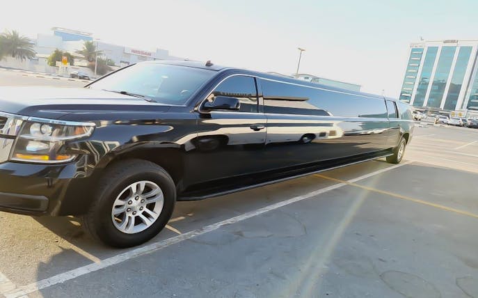 Black limousine parked in Dubai for private hourly rental with hotel transfers.
