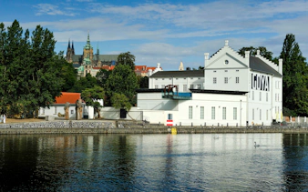 Museum Kampa by the Vltava River with Prague Castle in the background.