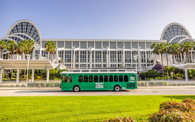 Green trolley in front of Orange County Convention Center, Orlando.
