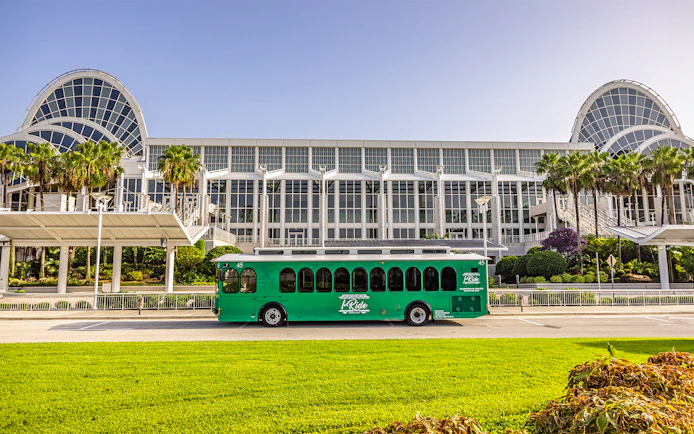 Green trolley in front of Orange County Convention Center, Orlando.