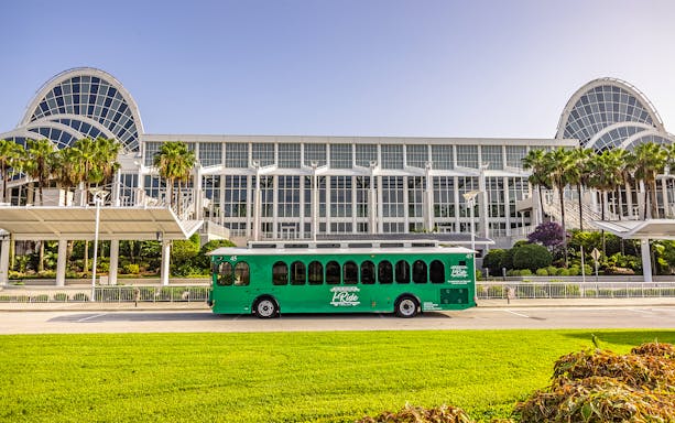 Green trolley in front of Orange County Convention Center, Orlando.
