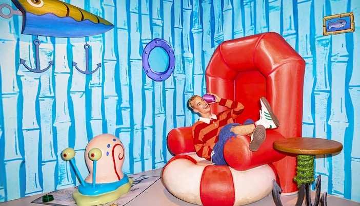 Person sitting in SpongeBob-themed room at WONDR Experience, Amsterdam.