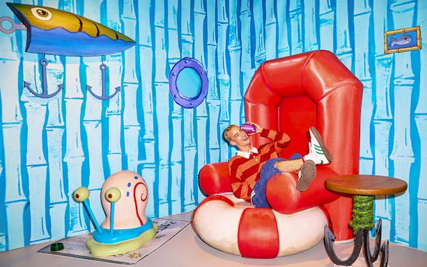 Person sitting in SpongeBob-themed room at WONDR Experience, Amsterdam.