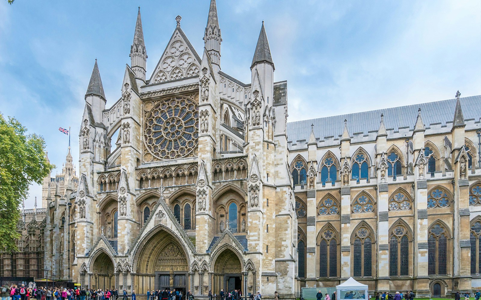 Westminster Abbey exterior with tourists, London.
