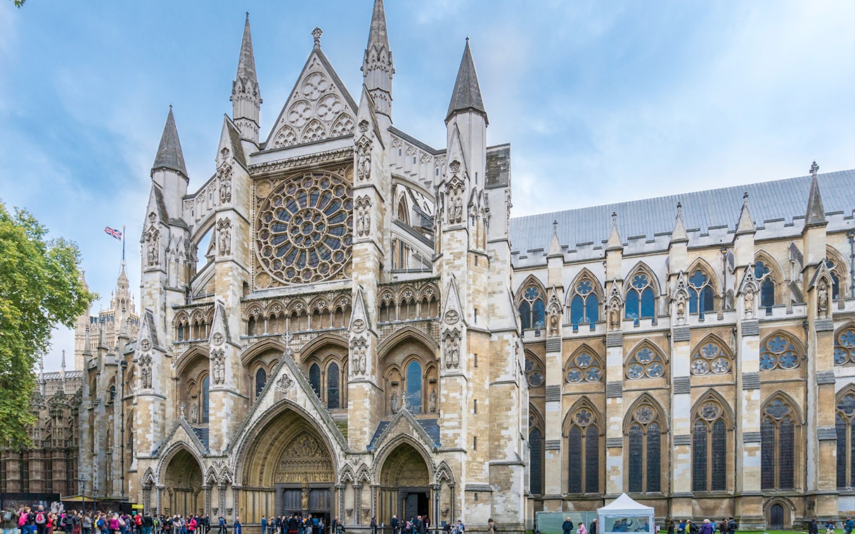 Westminster Abbey exterior with tourists, London.
