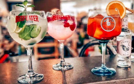 Three gin and tonic cocktails on a bar, featured on the Budapest cruise.