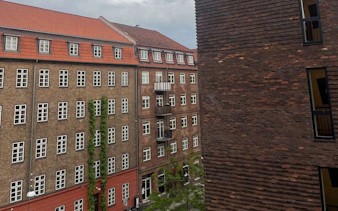 Historic brick buildings in Copenhagen, part of Andersen's self-guided city exploration game.