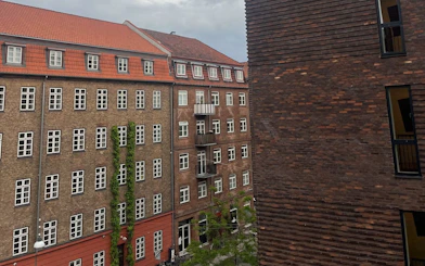 Historic brick buildings in Copenhagen, part of Andersen's self-guided city exploration game.