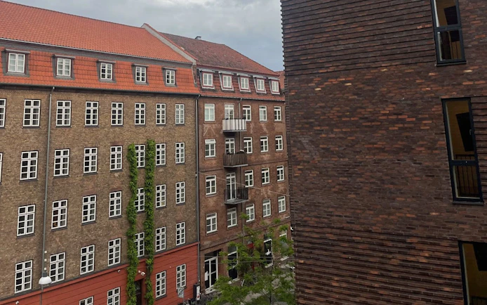 Historic brick buildings in Copenhagen, part of Andersen's self-guided city exploration game.
